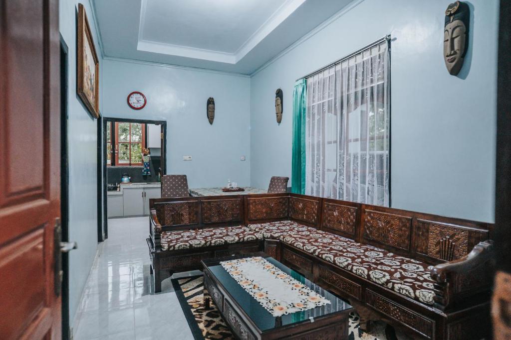 a living room with a couch and a window at Agus Hidden Homestay - Banjar Sweet Village in Banyuwangi