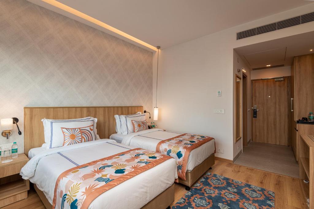 Postel nebo postele na pokoji v ubytování ExpoInn Suites and Convention