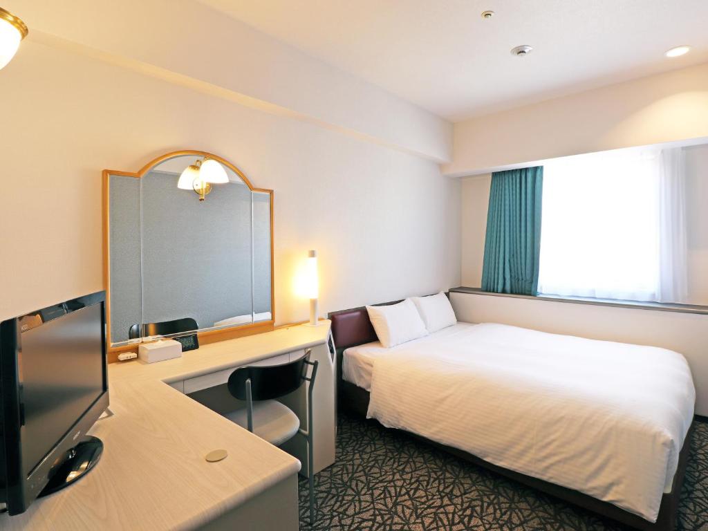 Postel nebo postele na pokoji v ubytování Chisun Hotel Yokohama Isezakicho