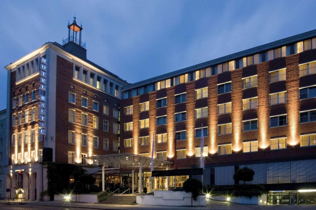 a large building with a cross on top of it at Vienna House by Wyndham Baltic Stralsund in Stralsund