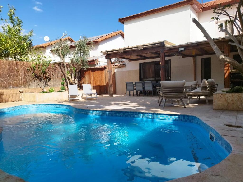 a swimming pool in the backyard of a house at YalaRent Fruit Tree Villa with Private Pool in Eilat