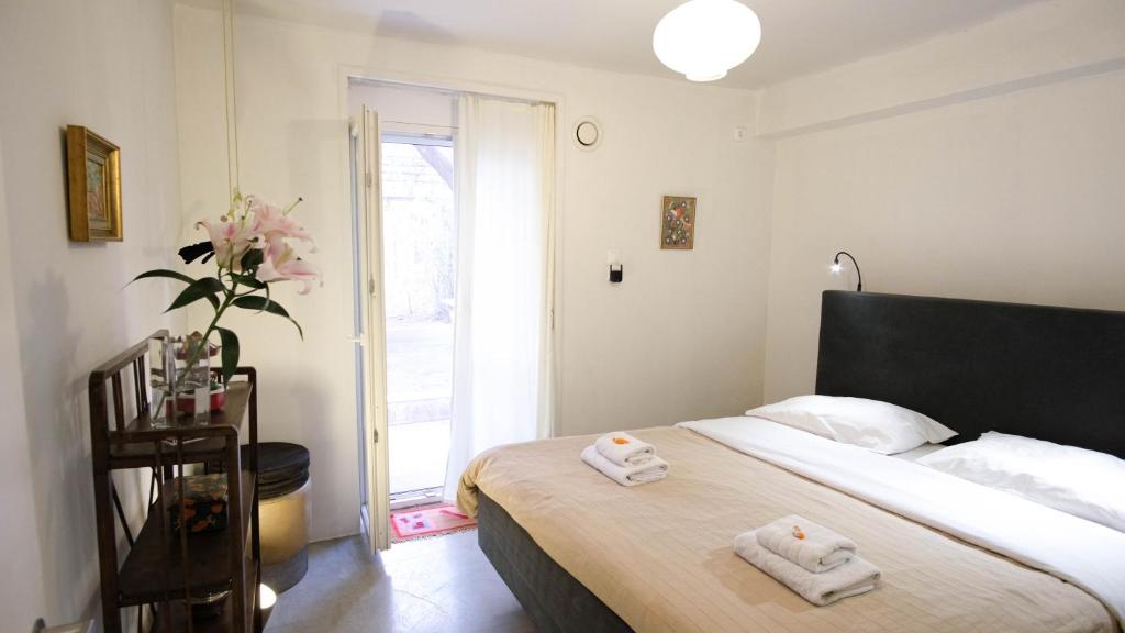 a bedroom with a bed with two towels on it at quiet and central FLAT with private backyard GARDEN in Athens