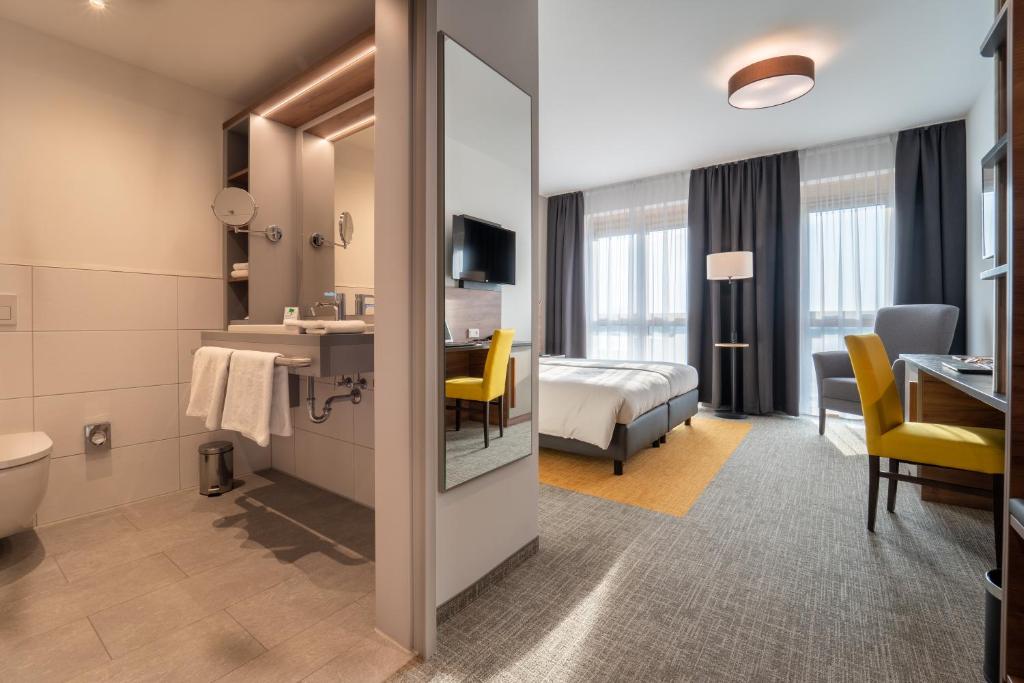 Postel nebo postele na pokoji v ubytování Hotel INCLUDiO