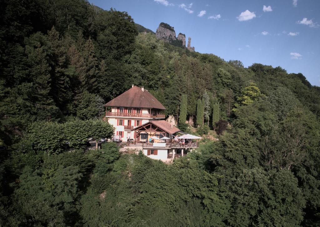 a house on the side of a mountain at Auberge du pont de l'Abîme in Gruffy
