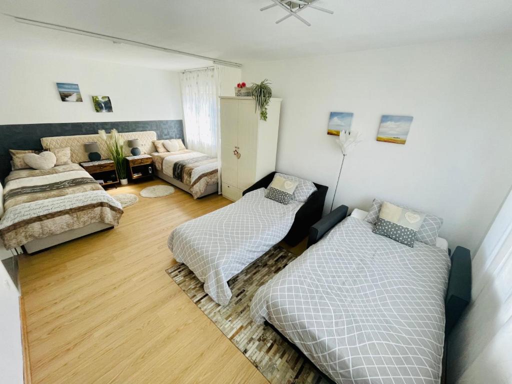 a living room with two beds and a couch at Apartment Messe Karlsruhe in Rheinstetten