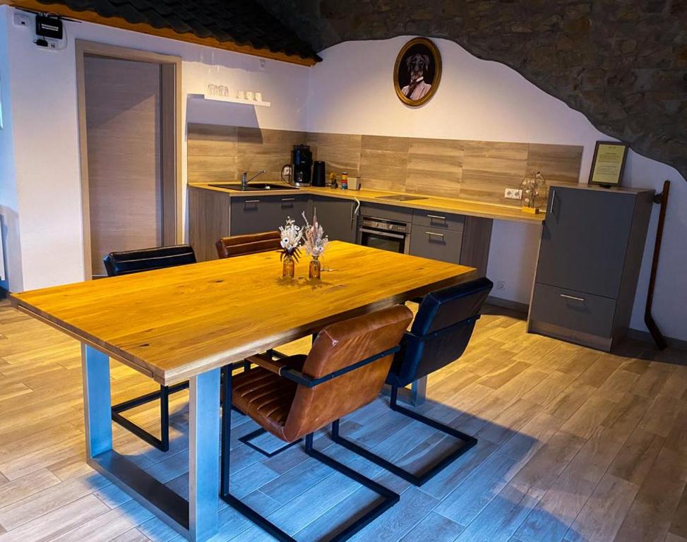 a kitchen with a wooden table and some chairs at Beim Hooch "Christ" in Brücktal