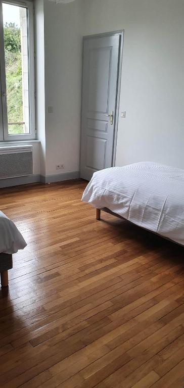 a bedroom with a bed and a wooden floor at Résidence Auger in Bourges