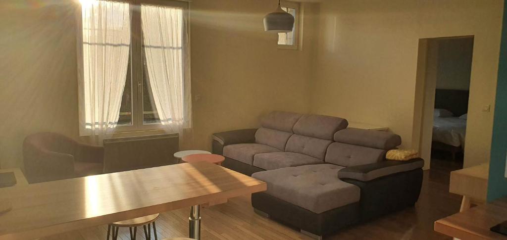 a living room with a couch and a table at Résidence Auger in Bourges