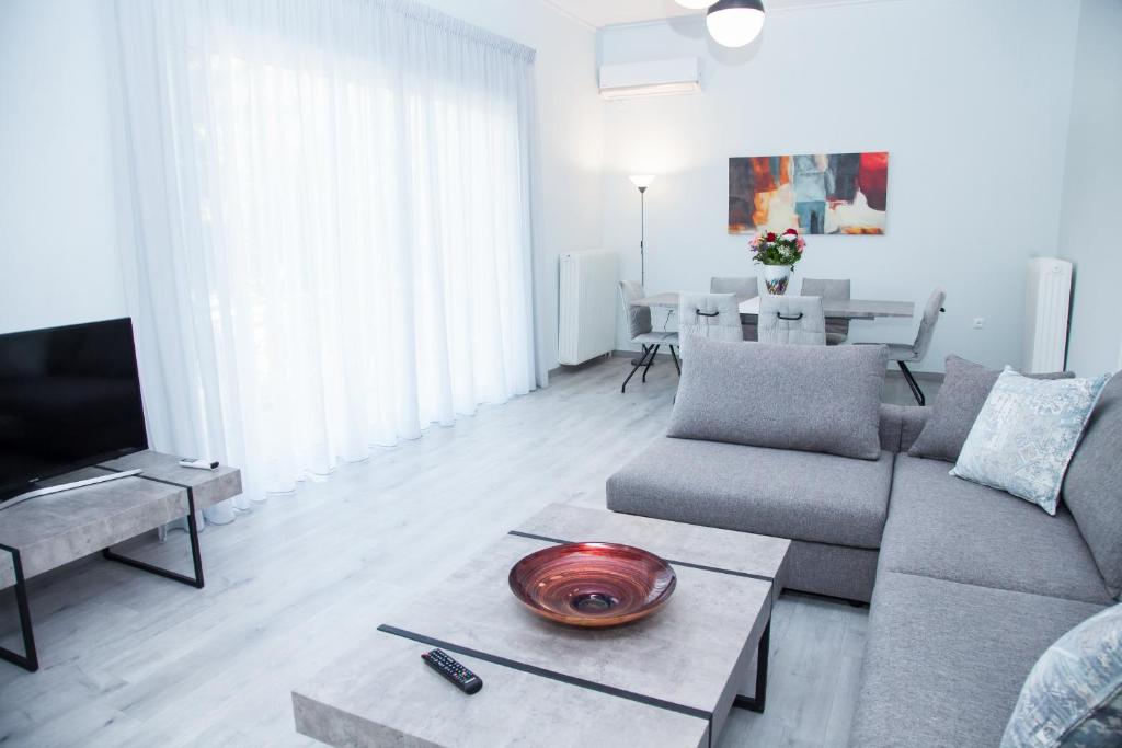 a living room with a couch and a table at Sunny and minimal apt in Glyfada with 3 bdrm in Athens