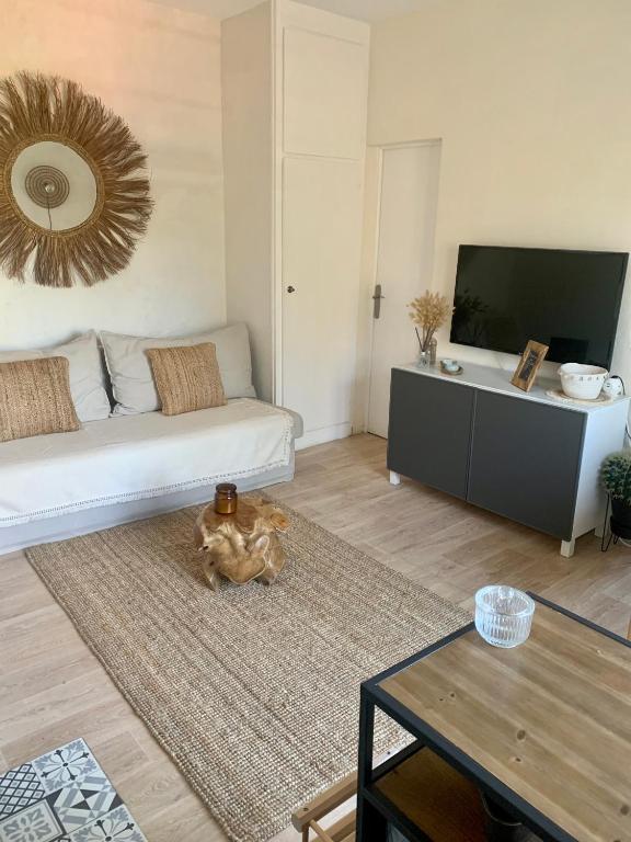 un salon avec un canapé et une table dans l'établissement Le Ptit Moulleau, à Arcachon