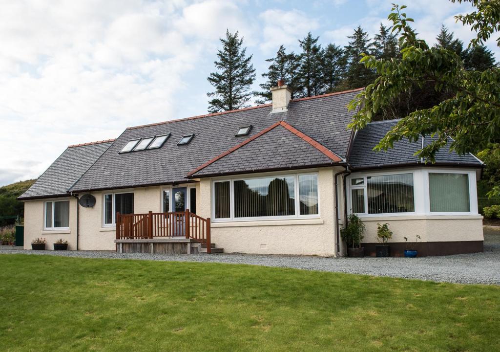 a detached house with a porch and a deck at The Roses B&B in Portree