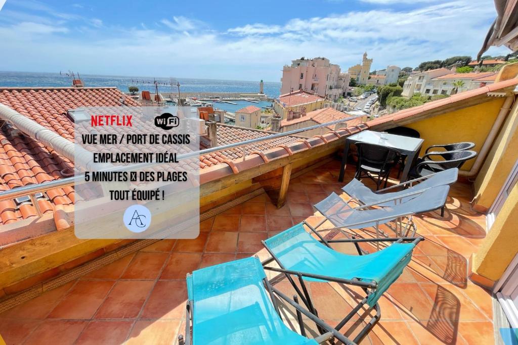 a balcony with two chairs and a sign on a roof at La Perle de CassisTerrasse Vue MerPort de Cassis in Cassis