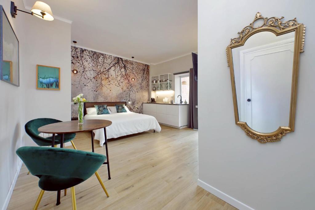 a bedroom with a bed and a table and a mirror at Aurelia Antica Terrace Apartment in Rome