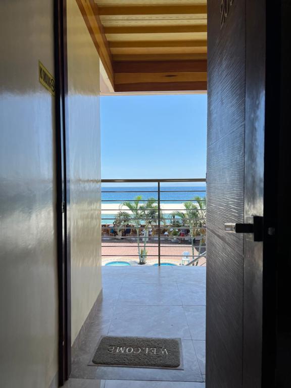 an open door with a view of the ocean from a building at GingGing Hotel And Resort in Oslob