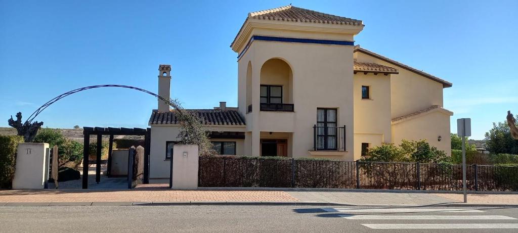 a large white house with a fence in front of it at HL 002 Holiday rentals 4 Bedrooms 4 Bathroom villa with private pool in Fuente Alamo