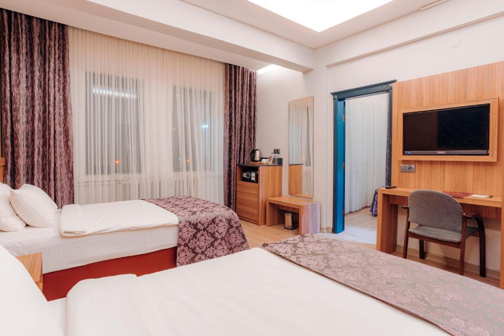 Кровать или кровати в номере Aksular Hotel
