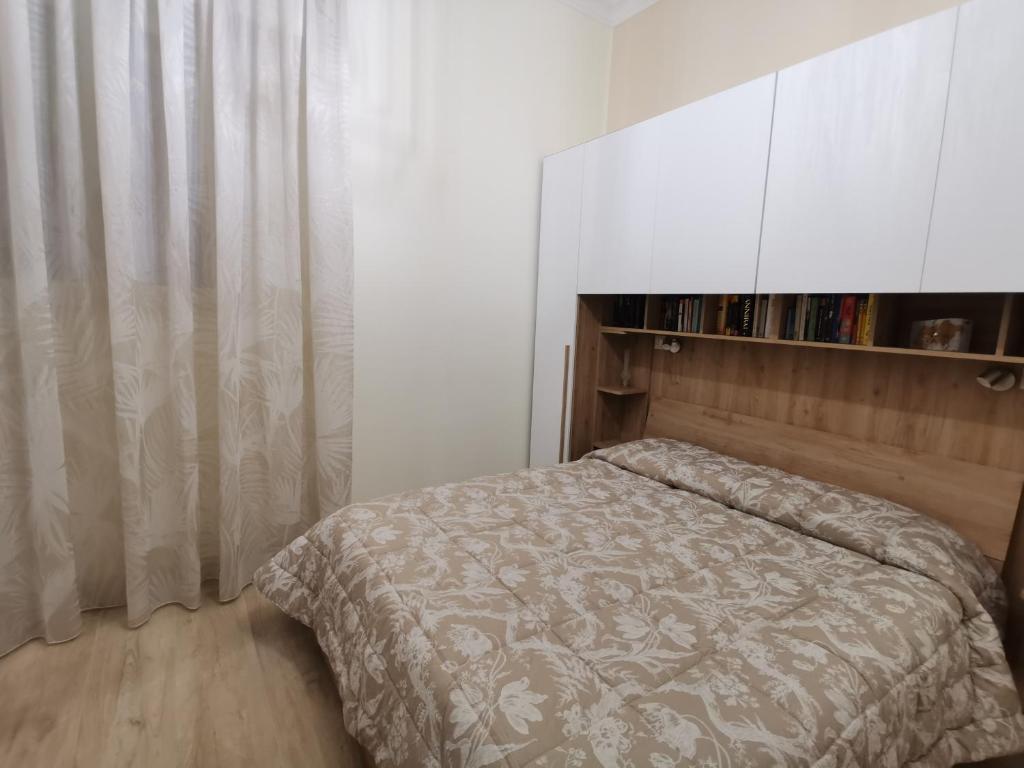a bedroom with a bed and a large white cabinet at Casa Marinella in Crotone