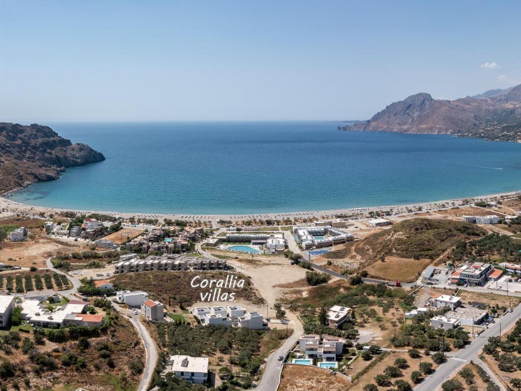 an aerial view of a resort next to the ocean at Corallia villas near the beach in Plakias