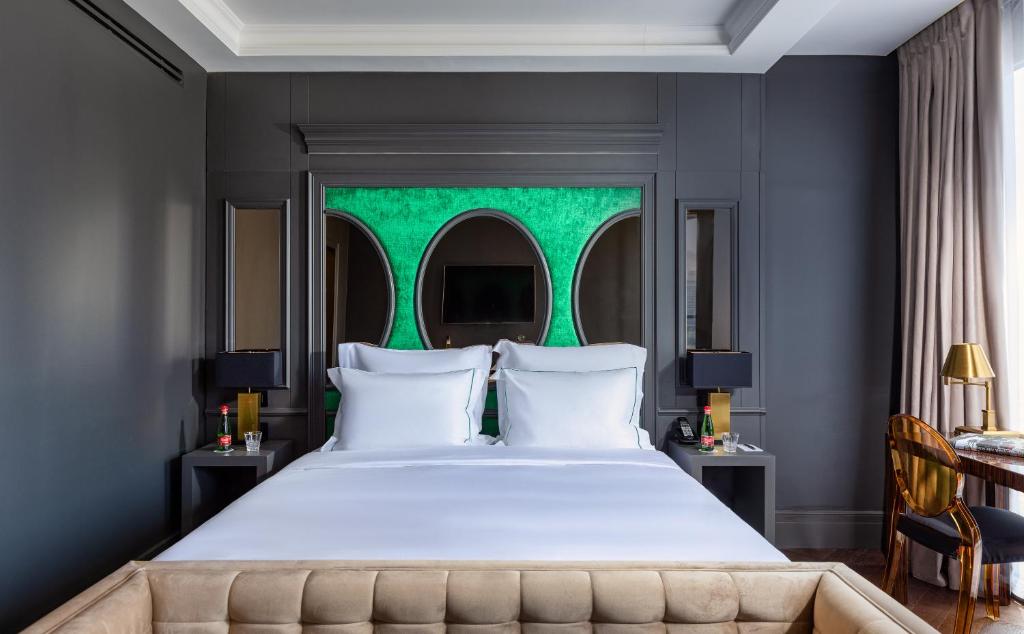 a bedroom with a large bed with a green window at Debrah Brown, a member of Brown Hotels in Tel Aviv