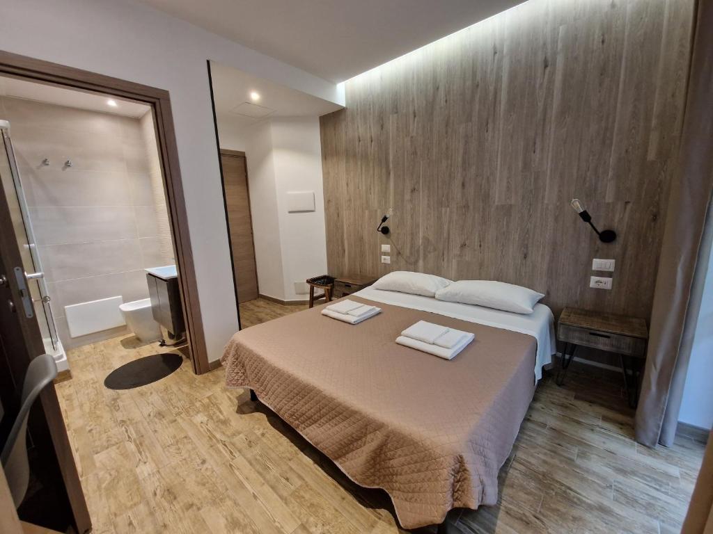 a bedroom with a bed with two towels on it at Arya Cagliari in Cagliari