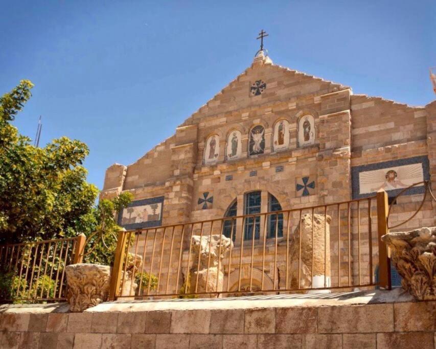 a church with a fence in front of it at Madaba Hills Apt in Madaba