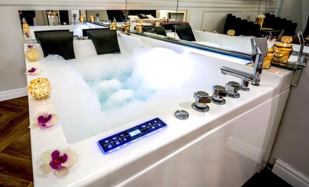 a white stove top oven with clouds in it at Apartament Shine Prywatne Jacuzzi Starowiślna Kraków in Kraków