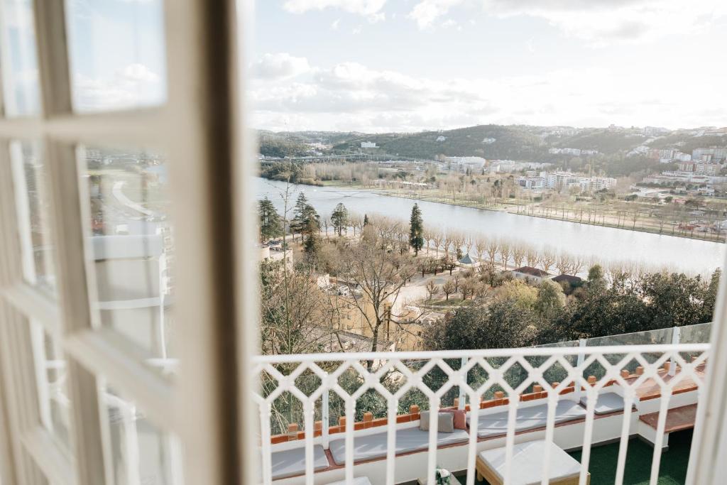 a view of a river from a window at AltoCanto in Coimbra