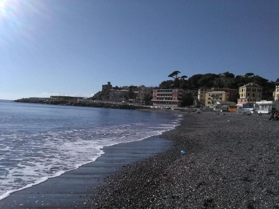 a beach with a rocky shoreline and the ocean at Splendid apartment near beaches and Boccadasse in Genoa