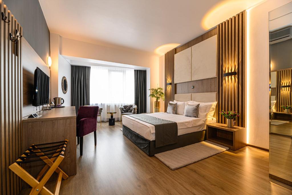 a hotel room with a bed and a kitchen at Unique Boutique in Bucharest
