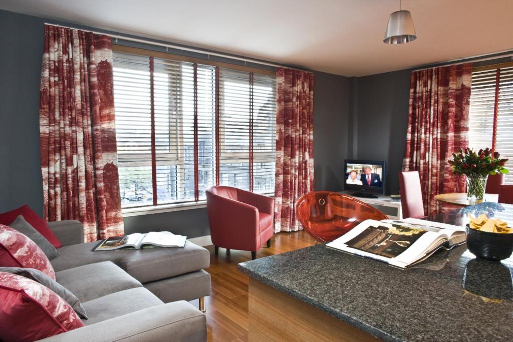 a living room with a couch and a table at Dreamhouse Apartments Glasgow City Centre in Glasgow