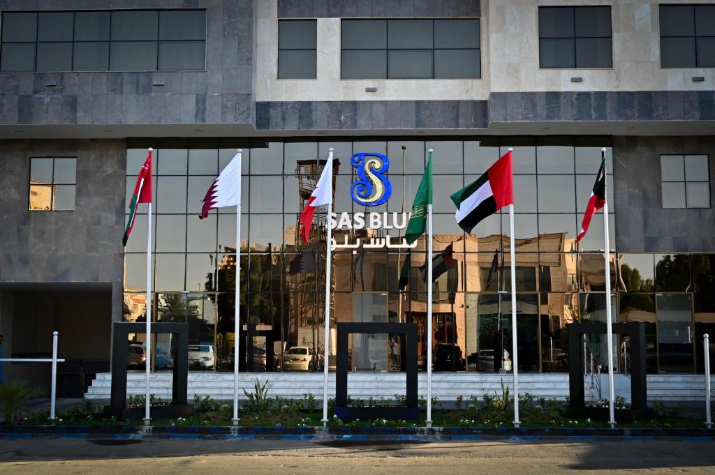 a group of flags in front of a building at sas blue suites in Jeddah