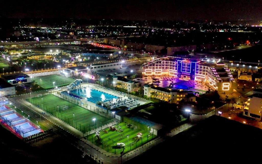 a view of a city at night with a pool at The Guard Hotel in Cairo