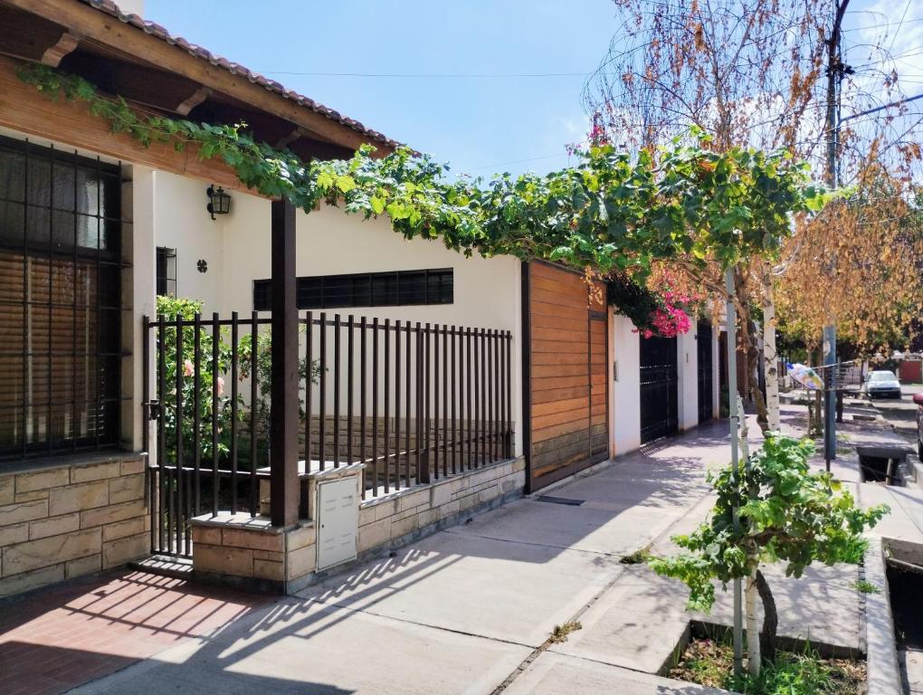 a house with a gate on a street at LA CASA DE LA PARRA in Godoy Cruz