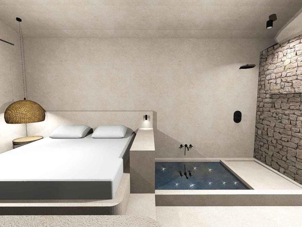 哈爾基的住宿－EliteDIMension Chalki，一间卧室配有一张床和浴缸
