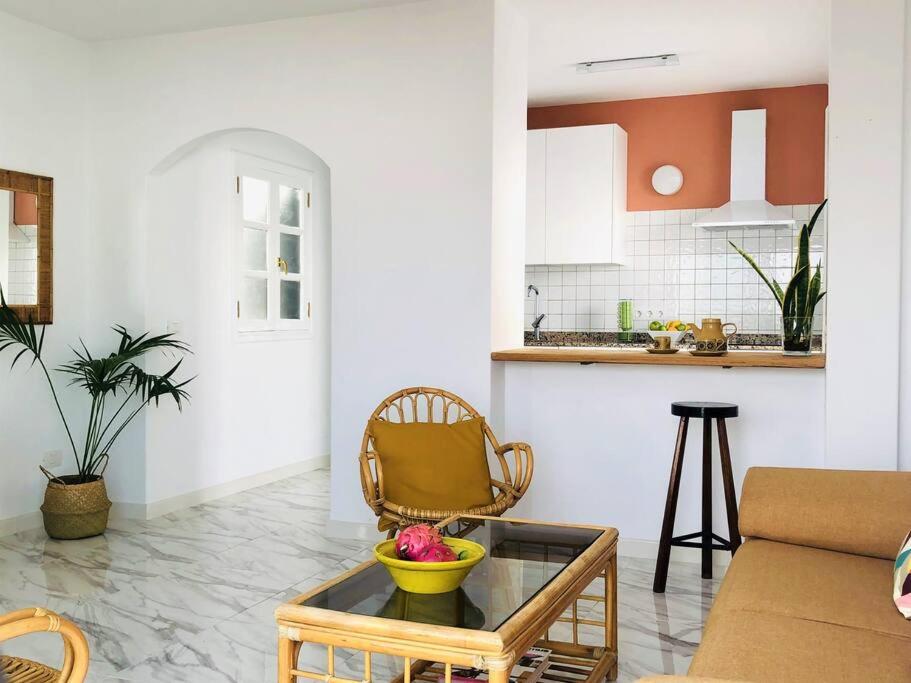 a living room with a bowl of fruit on a glass table at Casa Eloína in Playa Honda