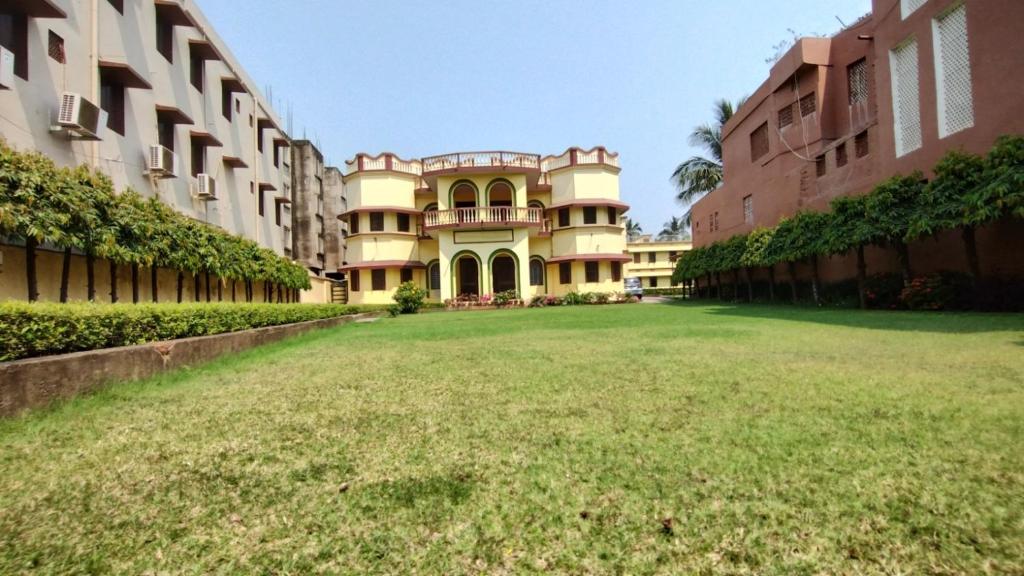 a large yard in front of a building at Bequest Stays Celebration in Puri