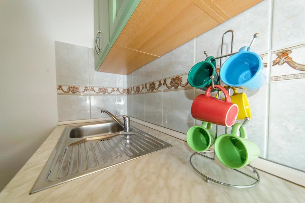 a kitchen with pots and pans hanging from the wall at Apartments & rooms Lucie in Posedarje