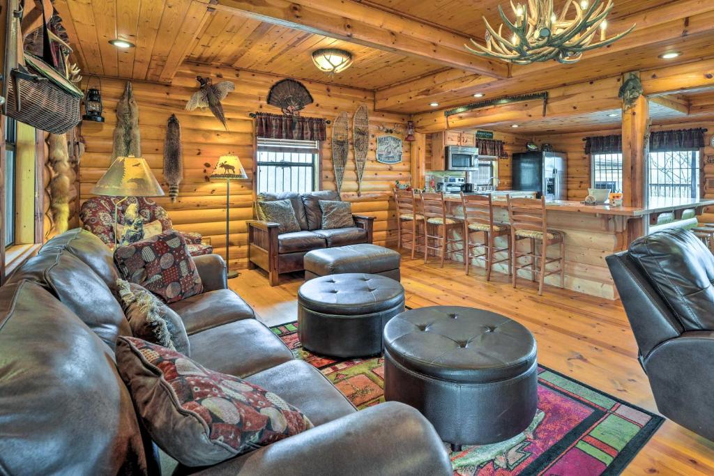 a living room with leather furniture and a bar at Rustic Cabin in Roaring River State Park! in Eagle Rock