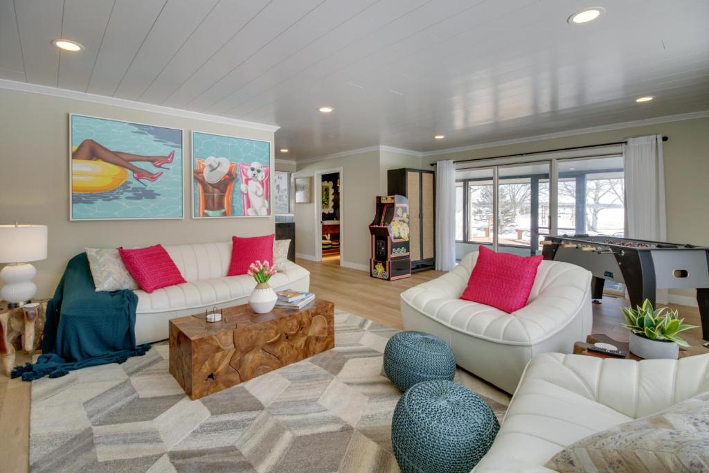 a living room with two white couches and a table at Home Rental on Detroit Lake Dock, Game Room! in Detroit Lakes