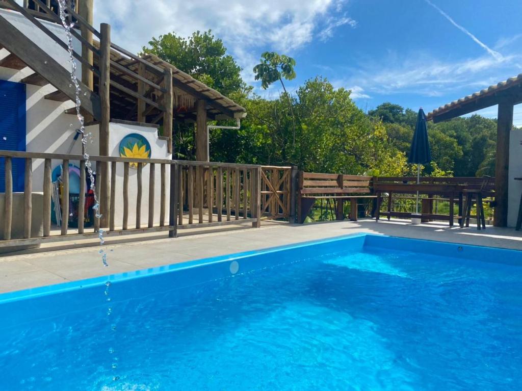 a swimming pool with a wooden fence and a swimming pool at Casa Boomerang in Marau