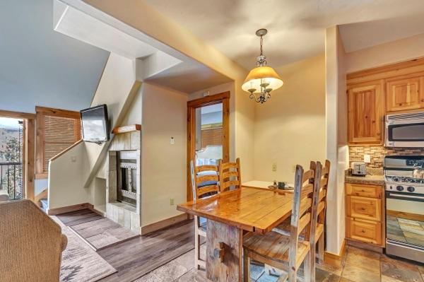 a kitchen with a wooden table and a dining room at Mountain Lodge at Telluride in Telluride