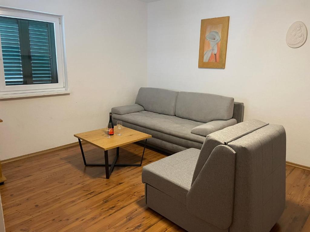 a living room with a couch and a table at Apartments Holiday Gavric in Trogir