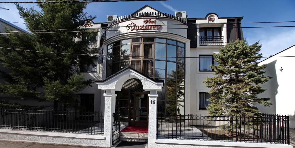 a building with a gate in front of it at Garni Hotel Vozarev in Belgrade