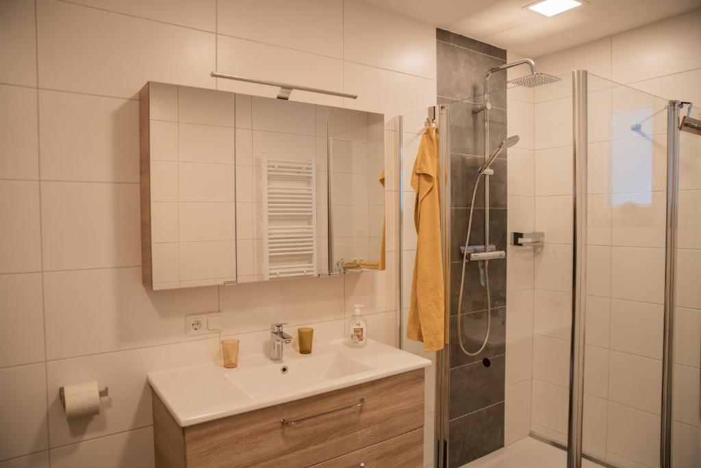 a bathroom with a sink and a shower at Ferienhaus Plöckenstein in Schwarzenberg am Bohmerwald