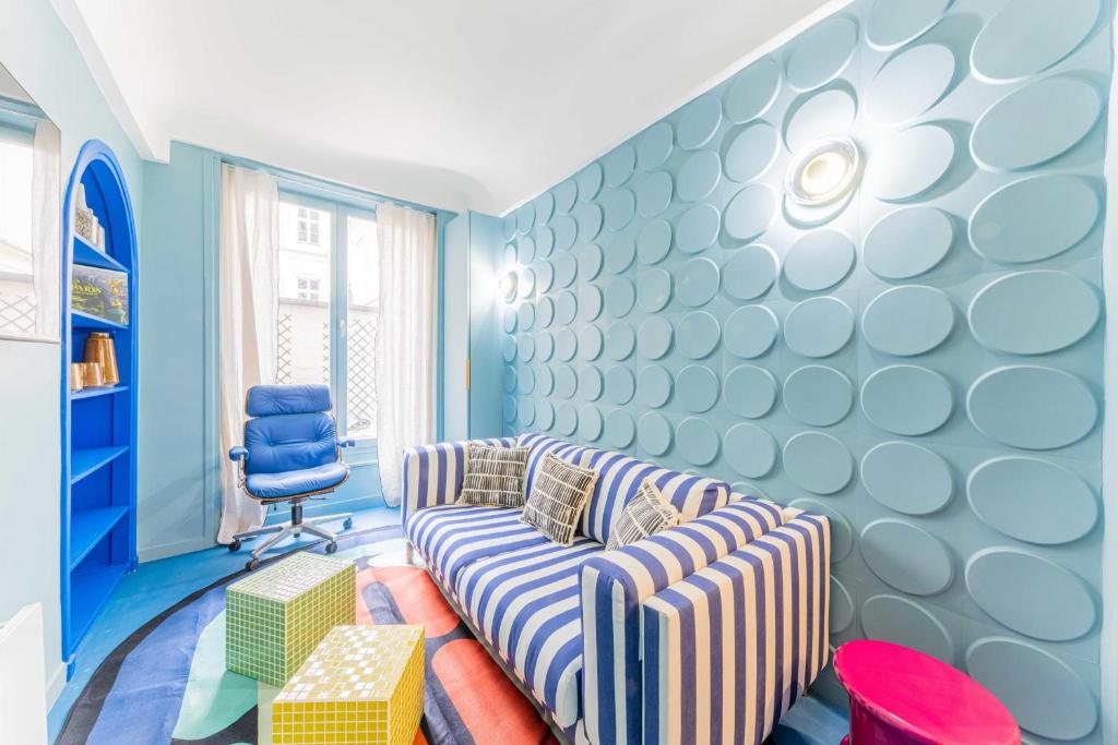 a living room with a couch and a chair at Emblematic apartment 2BR6P Saint honoré Rivoli in Paris