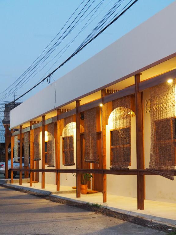 a building with windows on a street at Makai NAP in Ban Lam Pi