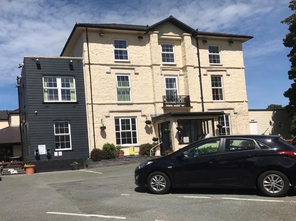 a black car parked in front of a building at Padarn Hotel in Llanberis