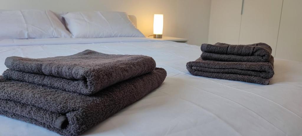 a pile of towels sitting on top of a bed at Ellas Modern Duplex City Center in Nicosia