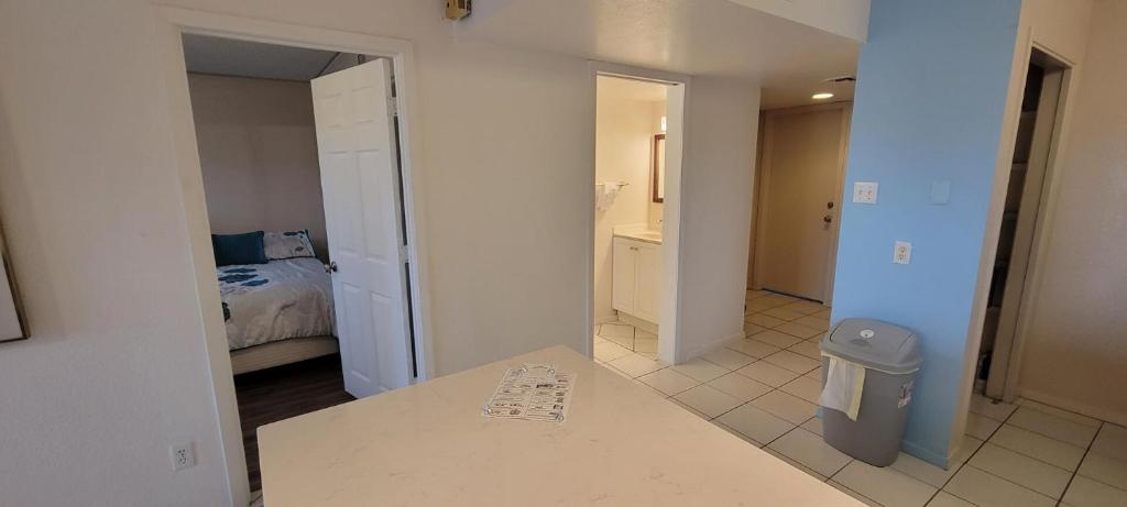 a room with a room with a bed and a bathroom at Gulfview I #213 in South Padre Island
