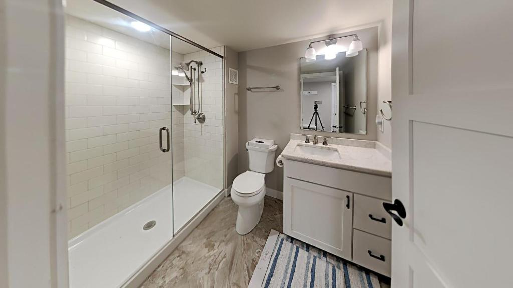 a bathroom with a toilet and a sink and a shower at Waters Edge Green Lake in Green Lake